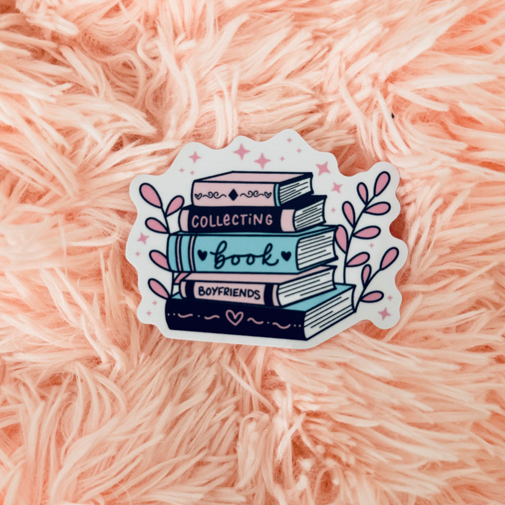 Bookish sticker - stack of colorful books saying "Collecting Book Boyfriends" on a pink fluffy surface